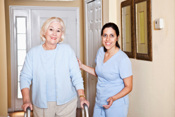 Nurse assisting elderly woman