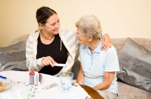 Daughter helping her mother with medications